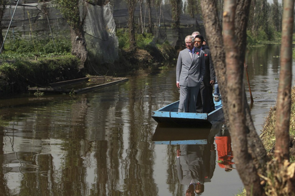 Britain's Prince Charles rides boat along with others while visiting the Chinampas in Xochimilco in Mexico City