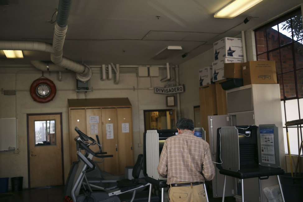 A voter casts his ballots at a polling place in a fire station on Election Day in San Francisco