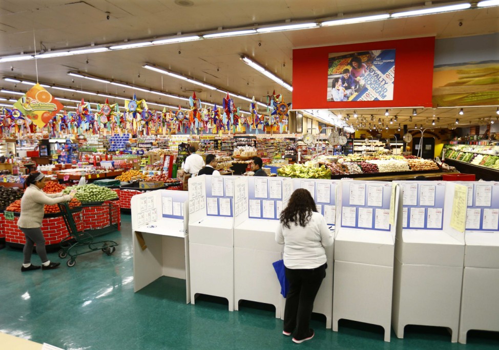 A woman votes at a polling station in a local grocery store during U.S. midterm elections, in National City