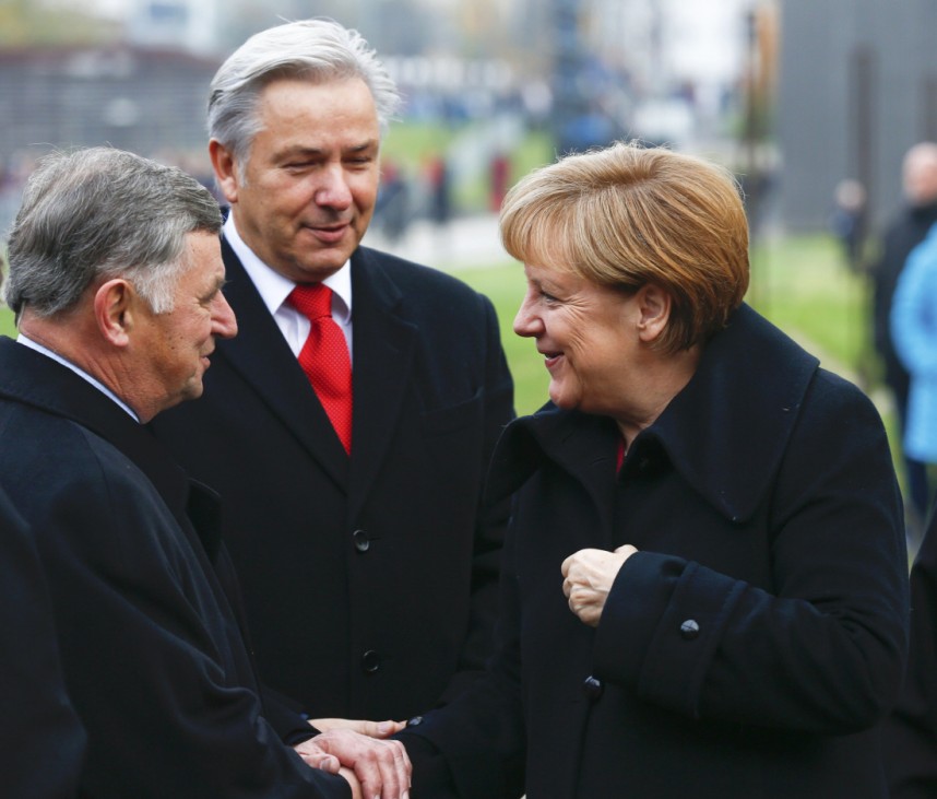 Berlin Mayor Wowereit watches as German Chancellor Merkel greets former Hungarian Prime Minister Nemeth for a ceremony marking the 25th anniversary of the fall of the Berlin Wall at a memorial in Bernauer Strasse in Berlin