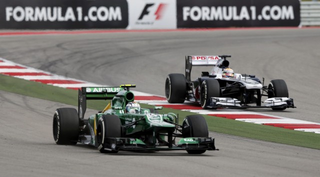 Giedo van der Garde of the Netherlands tries to get back onto the track next to Pastor Maldonaldo of Venezuela during the qualifying session of the Austin F1 Grand Prix at the Circuit of the Americas in Austin