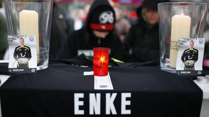 Young supporter of Germany's national goalkeeper Robert Enke writes in book of condolences outside headquarters of Germany's first Bundesliga soccer team Hanover 96 in Hanover