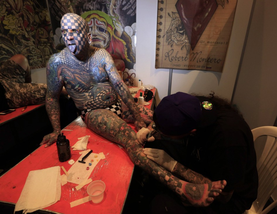 Matt Gone, also known as 'The Checkered Man', is tattooed during a tattoo convention in Bogota