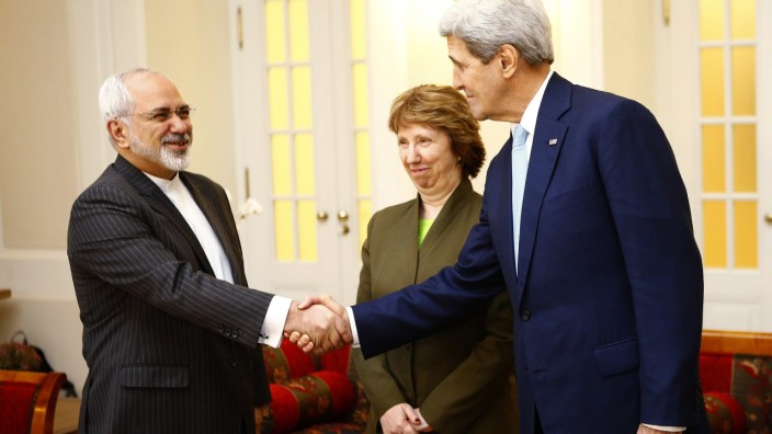 U.S. Secretary of State Kerry and Iranian FM Zarif shake hands as EU envoy Ashton watchesbefore a meeting in Vienna