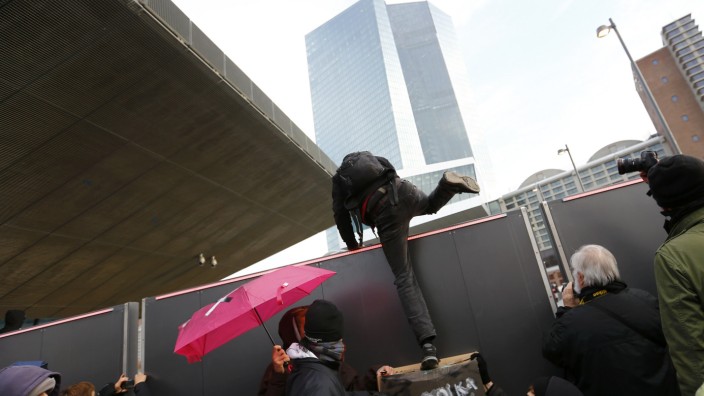 Blockupy protesters get over a fence to the new European Central Bank (ECB) headquarters during a demonstration in Frankfurt