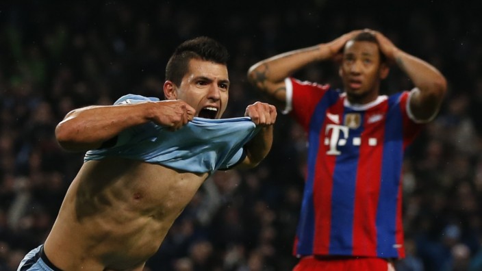 Manchester City's Aguero celebrates after he scored the winning goal as Bayern Munich's Boateng reacts during their Champions League Group E soccer match in Manchester