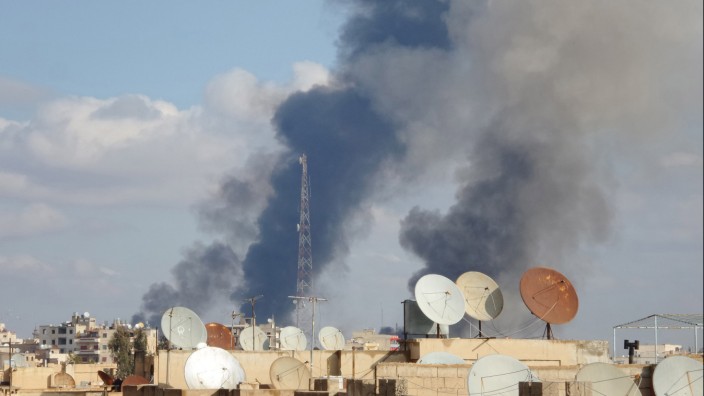 Smoke rises after what activists said were airstrikes by forces loyal to Syria's President Assad in Raqqa, which is controlled by the Islamic State