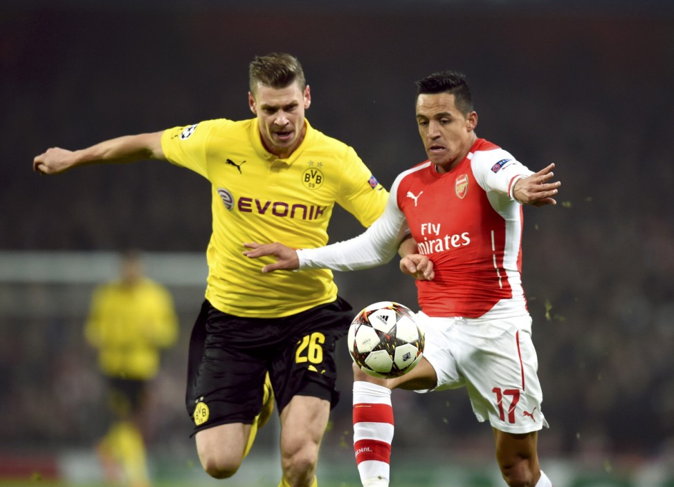 Borussia Dortmund's Piszczek challenges Arsenal's Sanchez in Champions League match in London
