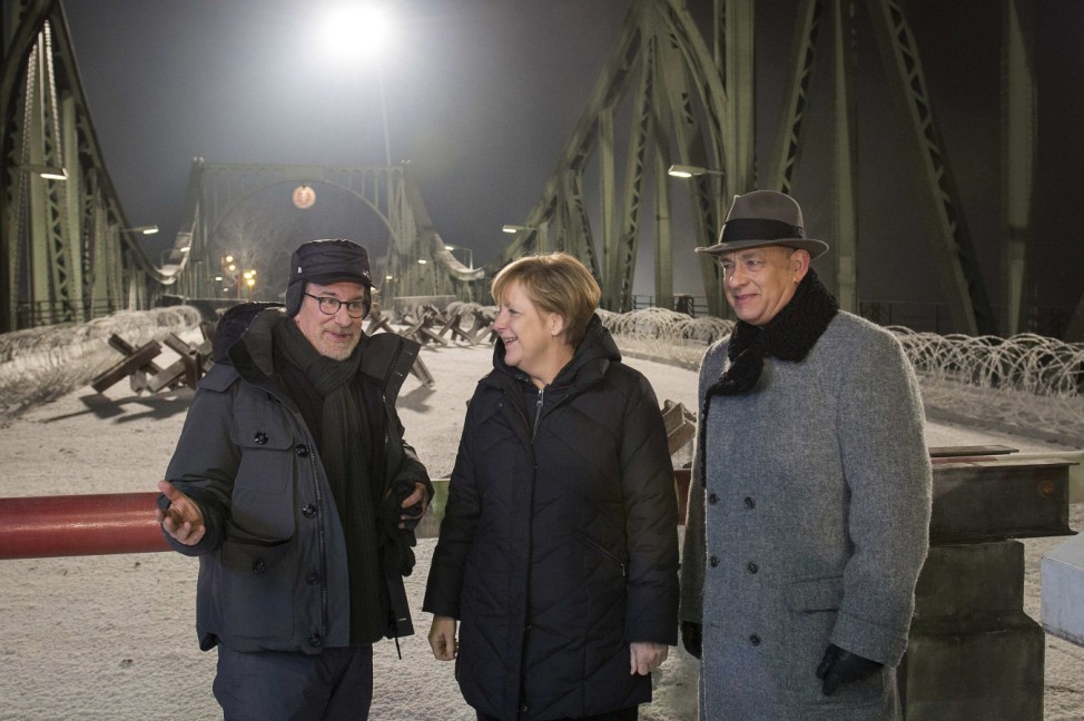 Handout showing Spielberg speaking with Merkel as Hanks, at a set at Glienicke Bridge
