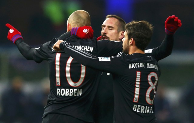 Bayern Munich's Robben celebrates with team mates Ribery and Bernat after he scored a goal against Hertha Berlin during their German first division Bundesliga soccer match in Berlin