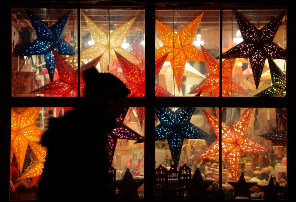a person passes a window with Christmas decoration in Hannover, northern Germany.