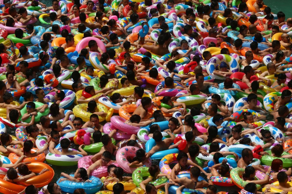 This picture taken on July 25, 2014 shows people cooling off in a waterpark in Suining, southwest China's Sichuan province.