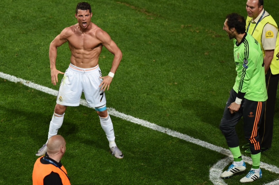 Real Madrid's Portuguese forward Cristiano Ronaldo (L) celebrates after scoring during the UEFA Champions League Final Real Madrid vs Atletico de Madrid at Luz stadium in Lisbon, on May 24, 2014.