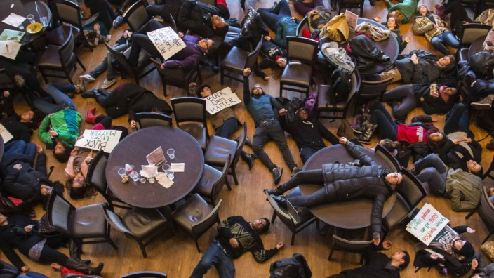 Student activists stage a 'die-in' as part of the nationwide 'Hands up, walk out' protest at Washington University in St. Louis