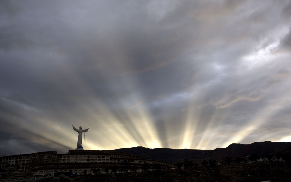 The last rays of the sun are seen at dusk at a cemetery in Yungay, Peru,