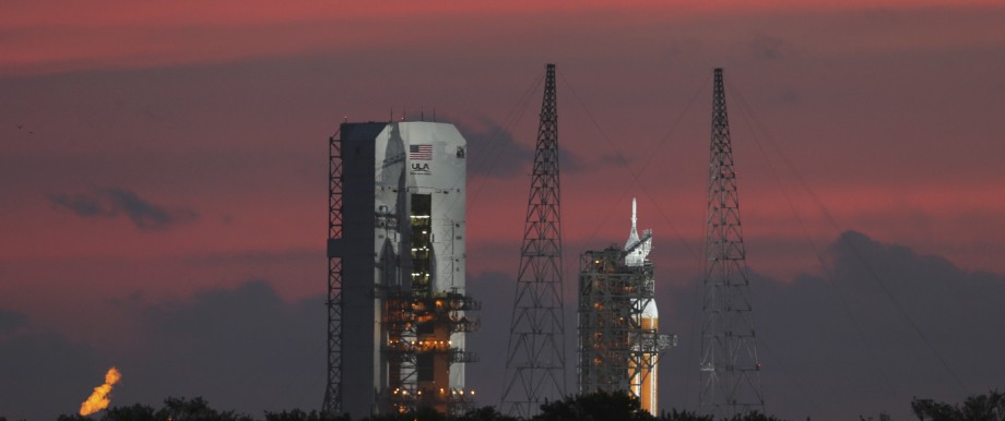 The Delta IV Heavy rocket carrying the Orion spacecraft sits on the launch pad awaiting liftoff in the sunrise in the Cape Canaveral