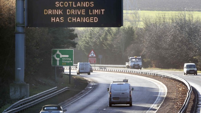 Drivers are informed by a sign that the drink-drive limit has changed in Scotland as they travel on the A9 road near Perth in central Scotland