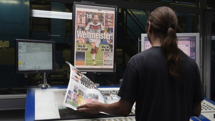 A printer controls files of German newspaper 'Bild' after Germany won the 2014 Brazil World Cup final soccer match, at printing plant in Berlin