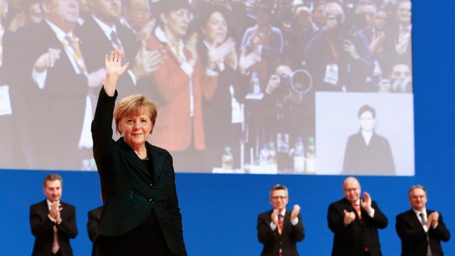 German Chancellor Merkel waves after she delivered her speech at the Christian Democratic Union (CDU) party convention in Cologne