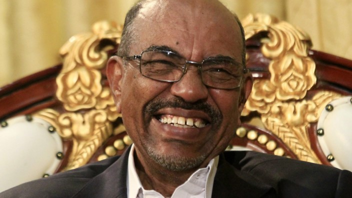Sudan's President Omar al-Bashir laughs during an interview with the Russia Today news channel at the Presidential Palace in Khartoum