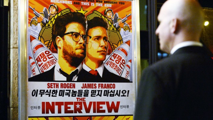 File photo of a security guard standing at the entrance of United Artists theater during the premiere of the film 'The Interview' in Los Angeles