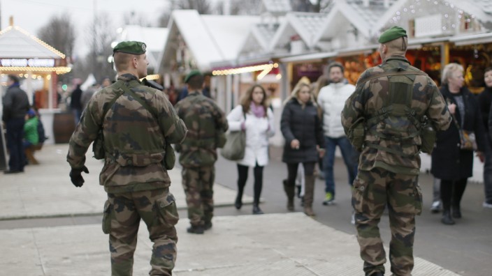 French soldiers patrol the Christmas market on the Champs Elysees in Paris as part of the 'Vigipirate' security plan
