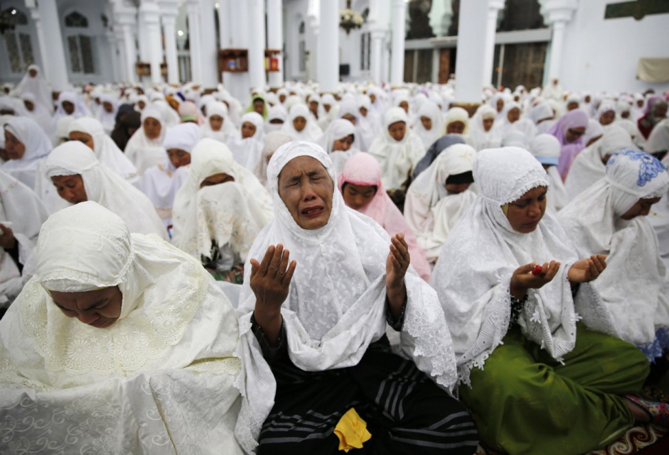 Acehnese women attend a mass prayer for the 2004 tsunami victims at Baiturrahman Grand Mosque in Banda Aceh