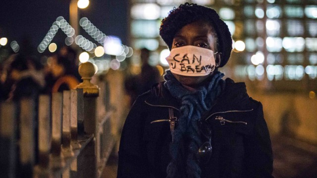 A female protester, demanding justice for Eric Garner, sports a face mask in Brooklyn, New York