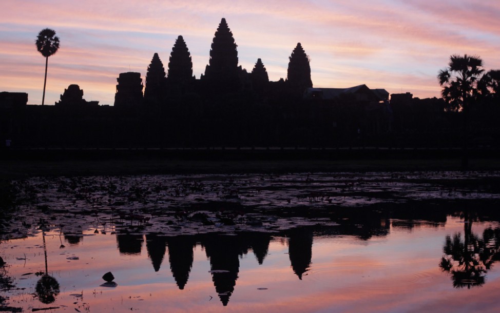 Cambodia's famous Angkor Wat temple is reflected in a pond during sunrise in Siem Reap