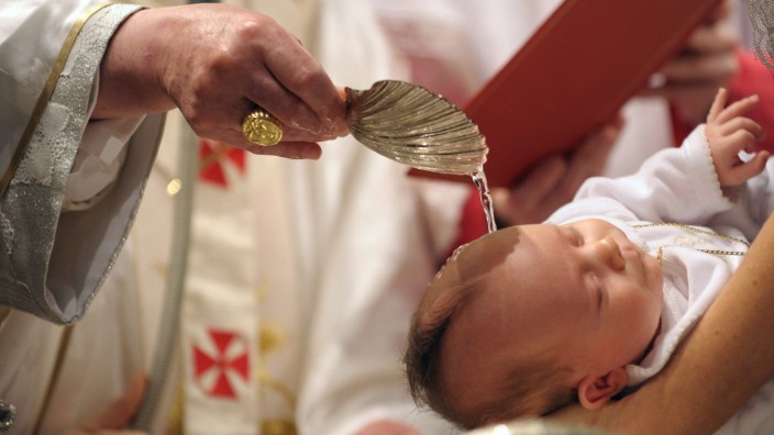Pope Benedict XVI baptise a baby during a mass in Sistine Chapel at the Vatican