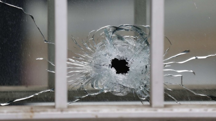 A bullet's impact is seen on a window at the scene after a shooting at the Paris offices of Charlie Hebdo, a satirical newspaper,