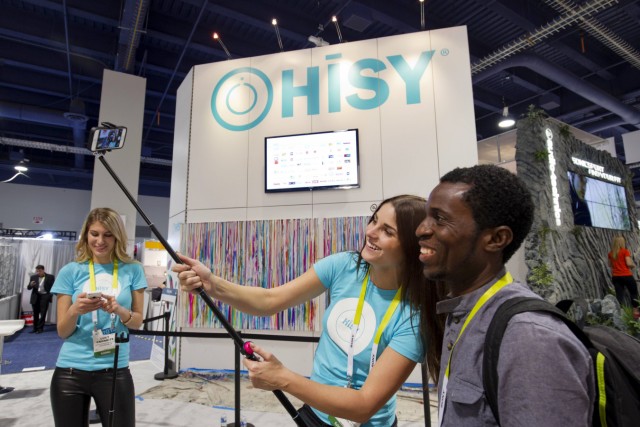 Christine Unruh takes a 'selfie' with Kelechi Okorie of Nigeria using a selfie stick and a HiSY bluetooth camera remote during the 2015 International Consumer Electronics Show (CES) in Las Vegas
