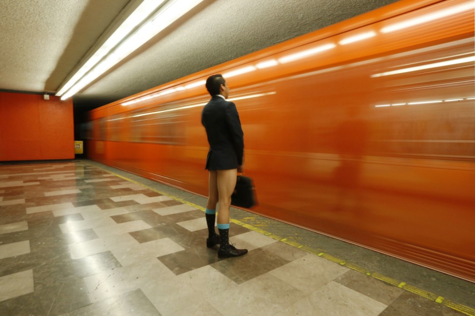 A passenger without pants waits for the subway train during 'The No Pants Subway Ride' in Mexico City