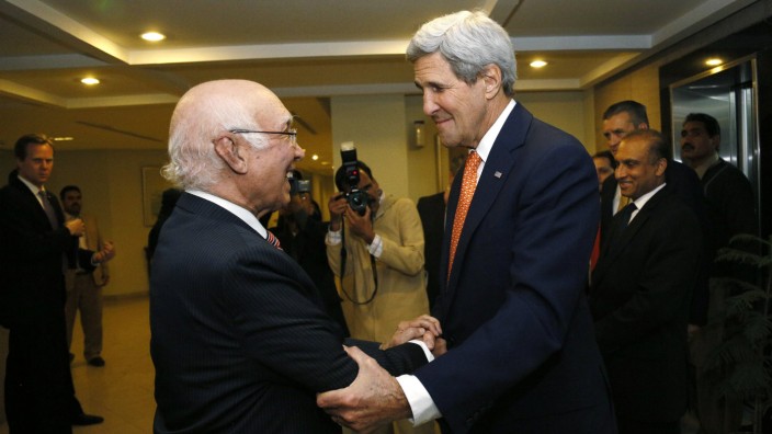 U.S. Secretary of State John Kerry is greeted by Pakistan's National Security Advisor Sartaj Aziz shortly after arriving in Islamabad