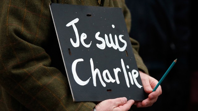 A man holds a 'Je suis Charlie' banner during a march in Liverpool
