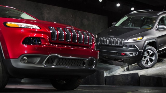 A Limited and a Trailhawk model 2014 Jeep Cherokee are seen on stage at the New York International Auto Show in New York