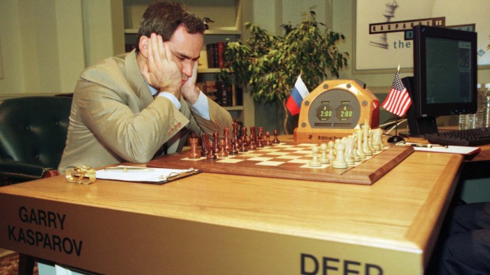 World chess champion Garry Kasparov studies the  board shortly before game two of the match against ..