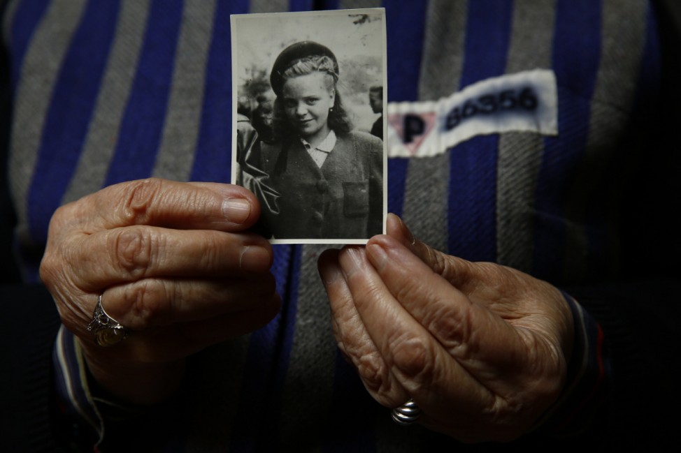 Auschwitz death camp survivor Jadwiga Bogucka holds a picture of herself from 1944 in Warsaw