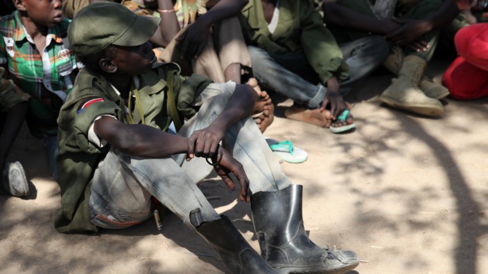 Rebel child soldiers gather in Gumuruk, as they prepare to handover their weapons at a demobilisation ceremony in Jonglei State, eastern South Sudan