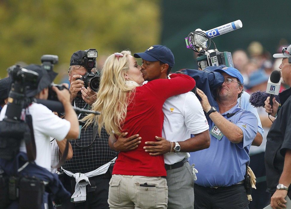 U.S team member Woods kisses girlfriend Vonn after Woods won his match and the U.S. won the Presidents Cup on the18th hole in the 2013 Presidents Cup golf tournament at Muirfield Village Golf Club in Dublin