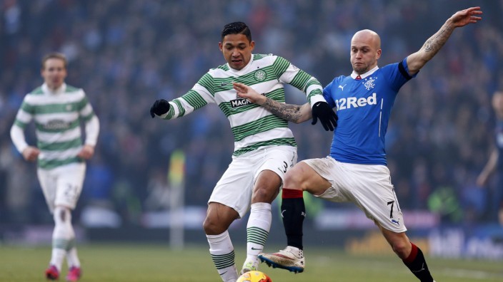 Celtic's Izaguirre is challenged by Rangers' Law during their Scottish League Cup semi final soccer match in Glasgow