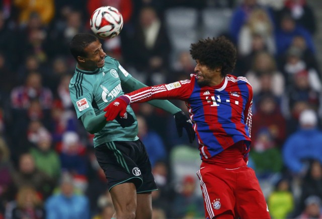 Bayern Munich's Dante and Schalke 04's Matip jump for a header during their Bundesliga soccer match in Munich