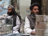 Afghan dealers wait for customers at a money market in Kandahar