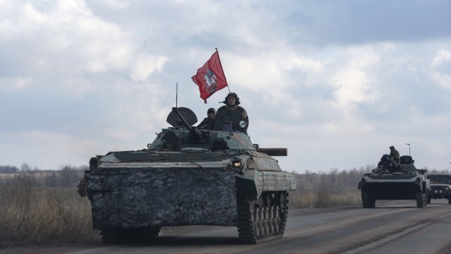 Members of the separatist self-proclaimed Donetsk People's Republic drive armoured vehicles near Yenakiieve