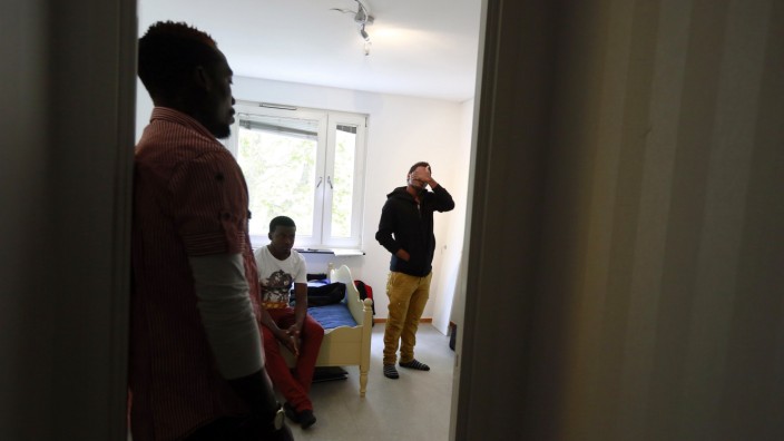 Edrisa Ssali, Katerega Musa, and Malik Douglas Darnba, from Uganda, are seen in the room they share in Sollentuna, a suburb of Stockholm