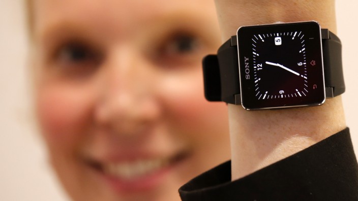 A model poses with a Sony SmartWatch 2 at the Sony booth during a media preview day at the IFA consumer electronics fair in Berlin