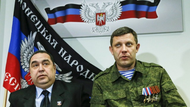 Zakharchenko, leader of the self-proclaimed DPR, and Plotnitsky, leader of the self-proclaimed LPR, attend a news conference in Donetsk