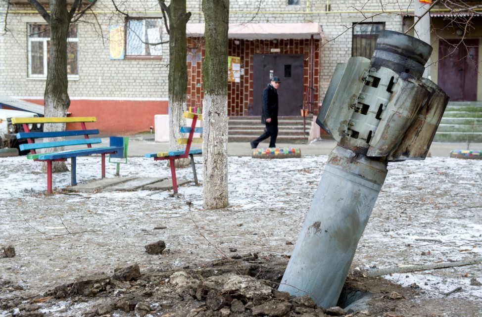 A man walks past an unexploded rocket in in the eastern Ukrainian city of Kramatorsk, in the Donetsk region, on February 11, 2015.