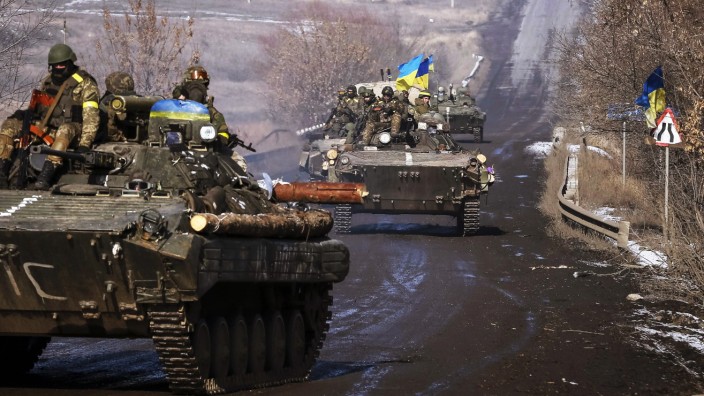 Members of the Ukrainian armed forces ride on armoured personnel carriers near Debaltseve