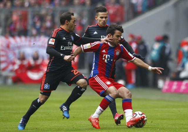 Bayern Munich's Bernat is tackled by Diaz and Stieber of Hamburger SV during German Bundesliga soccer match in Munich